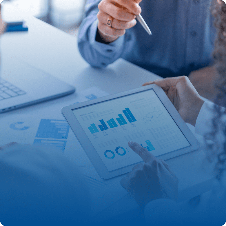 People analyzing data on a tablet.